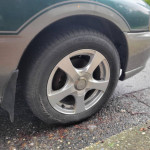 1997 Subaru Impreza Outback Sport with stylish aftermarket rims and good tire condition.