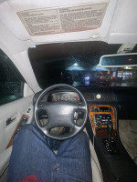 Interior view of a 1996 Infiniti J30 with leather seats, automatic transmission, and Bose sound system.