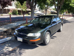 1997 Nissan Maxima with 50,000 miles, well-maintained, new brakes and tires, strong running condition in a residential area.