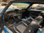 Interior view of a 1968 Ford Mustang Fastback showcasing black leather seats and original dashboard.