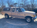 1996 Ford F-250 truck in excellent condition, equipped for towing with camper shell and roof rack