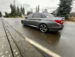 2020 Honda Accord Sport FWD in Modern Steel Metallic parked on a rainy street, showcasing sleek design and low mileage.
