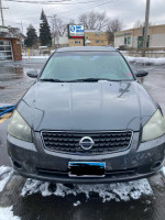 Front view of a 2006 Nissan Altima 3.5 SE for sale, showing minor wear and check engine light on.