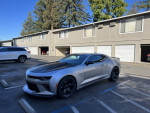 2018 Chevrolet Camaro 1SS in parking lot with 1LE performance package, white exterior and black accents.