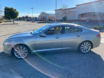 2010 Jaguar XF parked in a lot, showcasing its sleek design and clean body with minimal scratches.