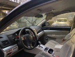 Interior of a 2012 Subaru Outback, showcasing dashboard, steering wheel, and seats with premium features.