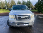 Front view of a 2008 Ford F150 XLT 4X4 pickup truck with minor rust and good tires.