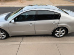 2004 Nissan Maxima with low mileage, featuring a sleek design and sunroof parked outdoors.
