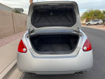 Open trunk of a 2004 Nissan Maxima with low mileage, showing spacious interior.