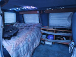 Interior of a 1992 Dodge Ram Van B250 Mark III camper with bed and storage.