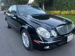 2004 Mercedes-Benz E320 Luxury sedan in black, low mileage, well-maintained, automatic transmission.