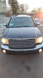 Front view of a Chrysler Aspen SUV with fog lights, showcasing its reliable condition for sale at $4,800.