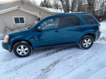 2007 Chevrolet Equinox LT FWD parked in snow, showcasing clean condition and good tires.