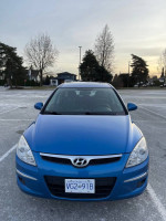 Front view of a blue 2011 Hyundai Elantra GLS hatchback parked outdoors.