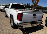 Rear view of a 2014 Chevrolet Silverado 1500 LT 4WD with chrome accents and a hard tonneau cover.