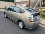 2007 Toyota Prius hatchback with leather seats, parked on the street, showcasing its sleek design.