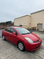 2007 Toyota Prius in red color, displaying its sleek design and low mileage for sale.