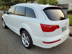 White 2009 Audi Q7 S-Line Premium Plus parked with a clean exterior and panoramic sunroof, showcasing a sleek design.