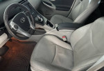 Interior view of a 2010 Toyota Prius with leather seats and modern dashboard controls.
