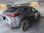 2023 Lexus NX 350h AWD parked in a garage, showcasing its sleek design and modern features.