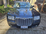 Front view of a steel blue Chrysler 300 Touring Sedan with 72,000 miles, featuring leather seats and a power sunroof.
