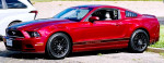 2014 Ruby Red Ford Mustang V6 parked with custom stripes and black wheels in great condition