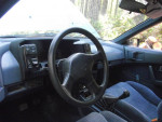 Interior view of a 1987 Nissan Pulsar NX with a manual transmission and modern stereo system.