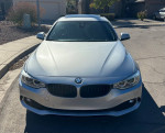 Front view of a silver 2015 BMW 435i with 115k miles, showcasing sleek design and sporty features.