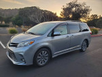 2020 Toyota Sienna XLE minivan in silver, showcasing a sleek design and exterior features, parked outdoors.