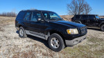 2001 Ford Explorer SUV in black, showing exterior and tires, with visible imperfections for sale.