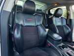 Interior view of a rare 2009 Dodge Charger R/T DAYTONA with black leather seats and red stitching.