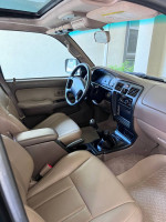 Interior view of a 1999 Toyota 4Runner SR5 with beige leather seats and manual transmission