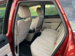 Interior view of a 2012 Mazda 5 showing spacious back seats and door details.