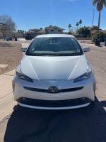 Front view of a 2019 Toyota Prius XLE in excellent condition with factory roof rack attachments.