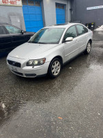 2006 Volvo S40 2.4i sedan in silver with recent service history parked on wet pavement.