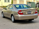 2002 Toyota Camry SE in excellent condition with low mileage, showcasing a flawless exterior and clean title.