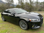 2018 Audi A5 Prestige quattro AWD hatchback in excellent condition, showcasing sleek design parked on grass.