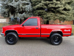1997 GMC Sierra 1500 SL 4WD, red pickup truck in great condition with matte black wheels, parked outdoors.