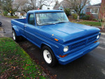 1972 Ford F-250 Camper Special dually truck parked on the street with a vibrant blue exterior.