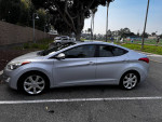 2013 Hyundai Elantra Limited FWD in silver with minor dings, GPS, leather seats, and sunroof parked in a lot