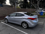 2013 Hyundai Elantra Limited in silver, parked, showcasing its sleek design and good condition.