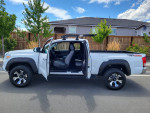 2017 Toyota Tacoma 4x4 extended cab with open doors, showcasing interior and new wheels.