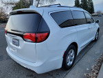 2017 Chrysler Pacifica Touring-L Plus minivan, white, parked on the street, excellent condition, seats 8 passengers.