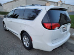 2017 Chrysler Pacifica Touring-L Plus in white parked, features power sliding doors and spacious interior.