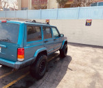 1999 Jeep Cherokee 4x4 in good condition with new lift kit and all-terrain tires, perfect for maintenance enthusiasts.