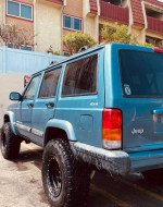 1999 Jeep Cherokee 4x4 with a Rubicon lift kit and BFG All-terrain tires parked in good condition