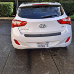 2013 Hyundai Elantra GT in white, showcasing rear view with custom rims and California plate.