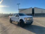 2017 Ford F350 Powerstroke Lariat in white with black leather interior, parked in a lot