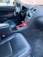 Interior view of a 2008 Lexus ES 350 showing black leather seats and wood trim dashboard.