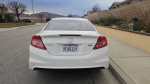 Rear view of a 2012 Honda Civic Si with clean title and excellent condition, parked on a street.